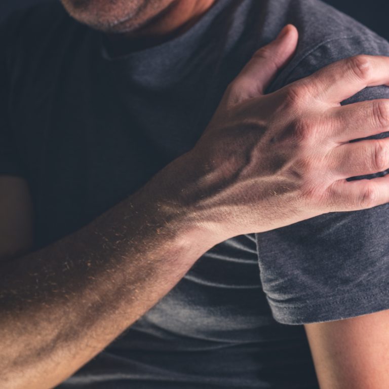 Aching frozen shoulder pain as symptom of rotator cuff tendinitis, adult caucasian male suffering from chronic bursitis, selective focus