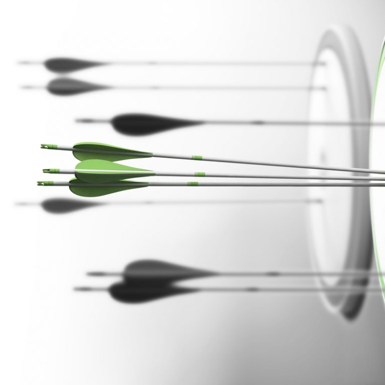Three targets with focus on the one in the center and arrows hitting the center. Concept of competitive excellence and performance.